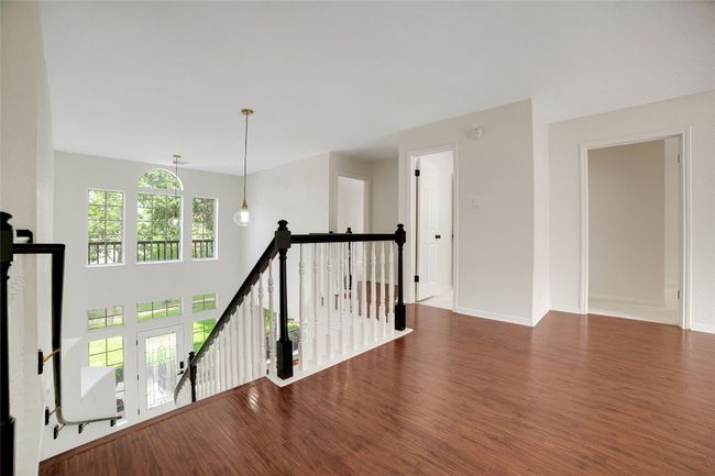 Corridor featuring an upstairs landing, wood finished floors | Image 21