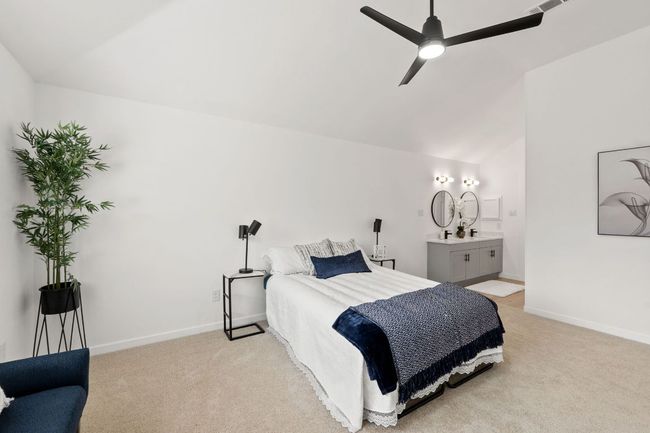 Main Bedroom featuring baseboards, lofted ceiling, and light colored carpet | Image 23