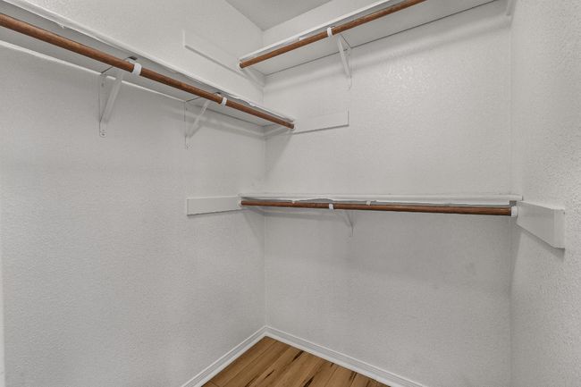 Spacious closet featuring wood finished floors | Image 14