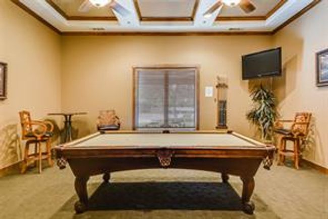 Recreation room with billiards table, carpet floors, a ceiling fan, coffered ceiling, and crown molding | Image 35