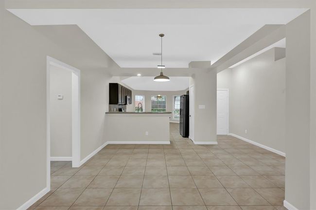 Living area with dining area ahead, and kitchen beyond that. | Image 15