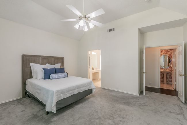 Bedroom featuring lofted ceiling, baseboards, visible vents, and carpet flooring | Image 28
