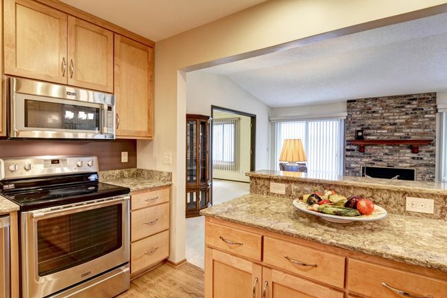 Kitchen opens into the living area & is brighten with a tubular skylight | Image 9