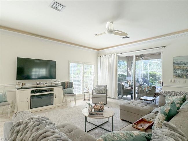 Tiled living room featuring crown molding and ceiling fan | Image 27