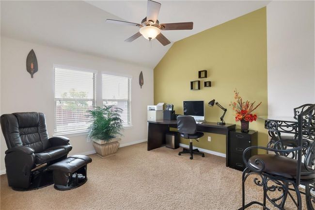 Office space with ceiling fan, carpet flooring, lofted ceiling, and baseboards | Image 10