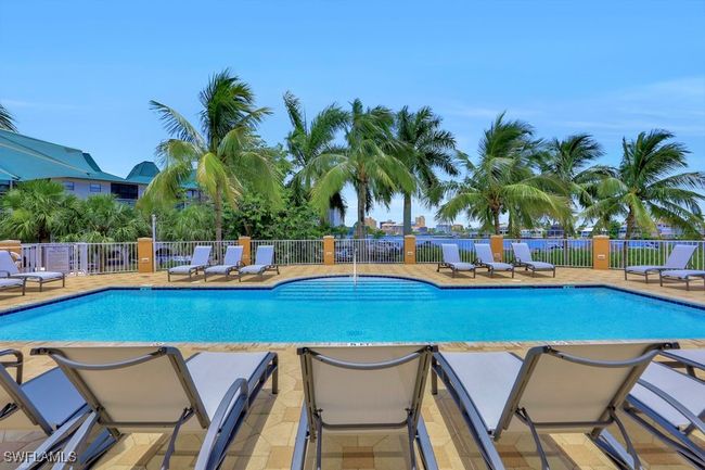 Community pool featuring fence and a patio area | Image 17
