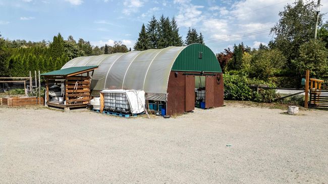 View of greenhouse with view of scattered trees | Image 29