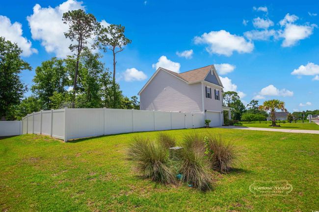 View of side of property featuring driveway and an attached garage | Image 39