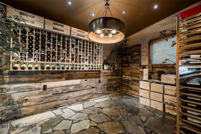 Main level wine room with flagstone flooring. | Image 46