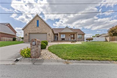 View of front of property with a garage and a front lawn | Image 1