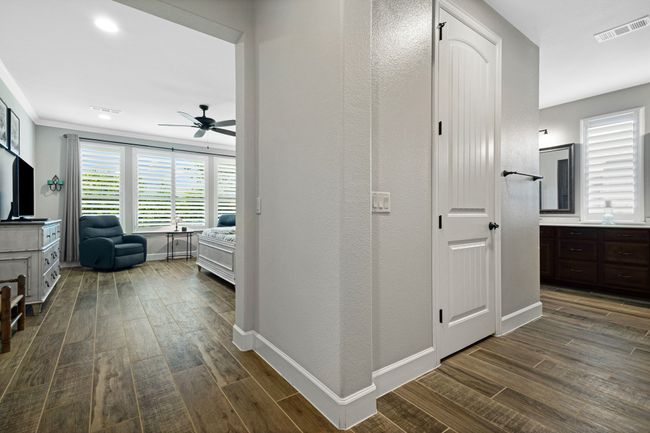 Hallway with dark wood-style flooring and baseboards | Image 28