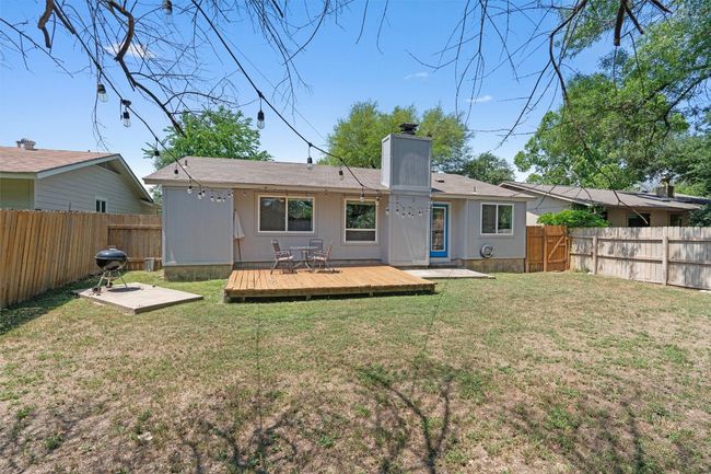 Back of house with a wooden deck and a chimney | Image 30