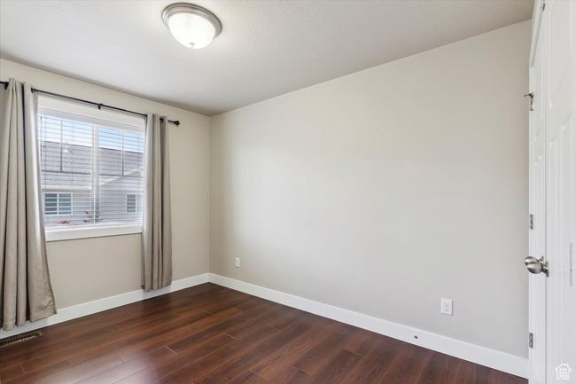 Unfurnished room with dark wood finished floors and baseboards | Image 28