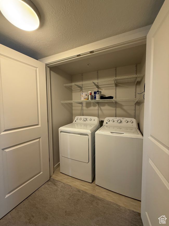 Laundry room with washer and dryer and light wood-type flooring | Image 7