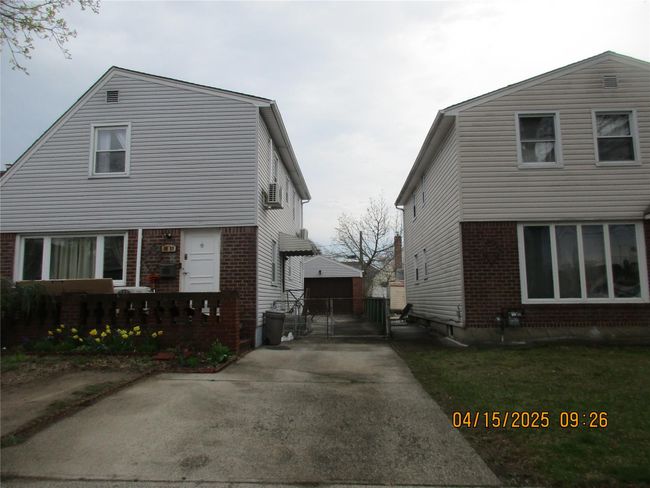 View of home's exterior with brick siding and a gate | Image 23