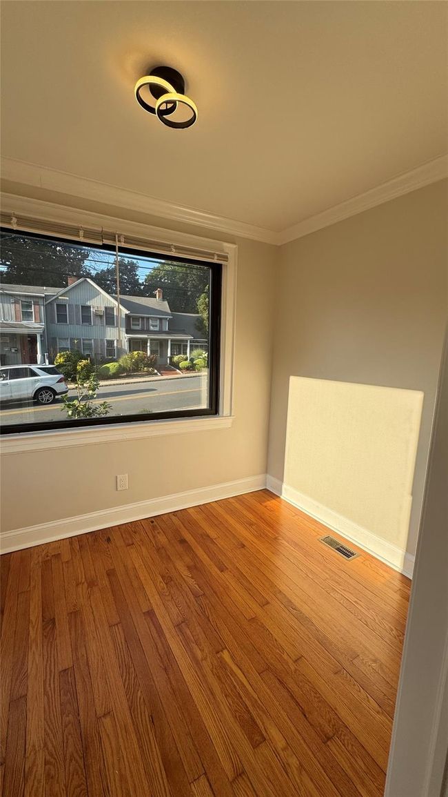 Unfurnished room with wood finished floors and ornamental molding | Image 14