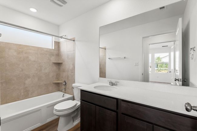Bathroom with vanity, wood finished floors, and bathing tub / shower combination | Image 20