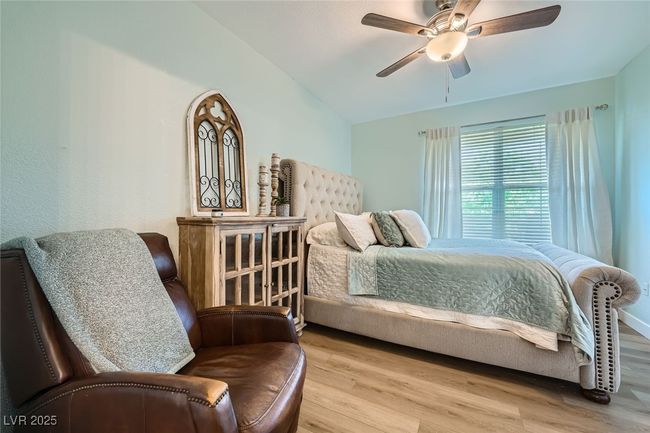 Bedroom featuring vaulted ceiling, wood finished floors, and ceiling fan | Image 13