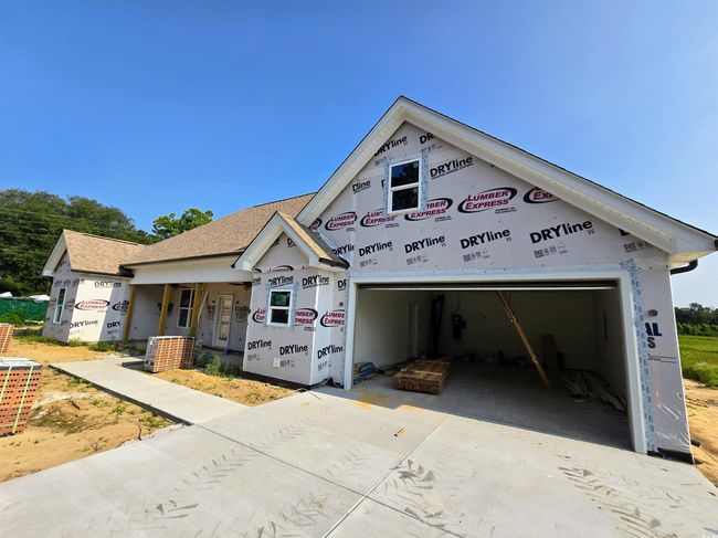 Property under construction featuring concrete driveway, a garage, and a shingled roof | Image 31