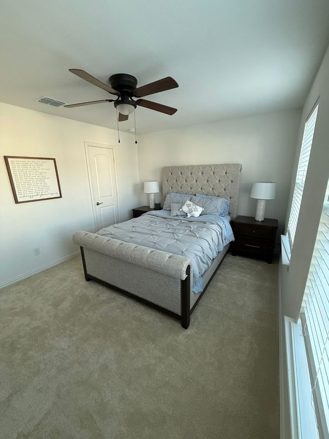 Carpeted bedroom with ceiling fan and baseboards | Image 16