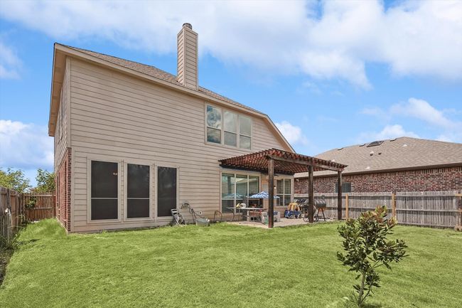 Back of house featuring a pergola, a chimney, a patio, and a fenced backyard | Image 32