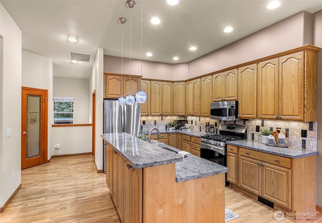 Notice the pantry area across from the kitchen, the door to the right is the laundry room and the no step entrance into the 3 car garage. | Image 10