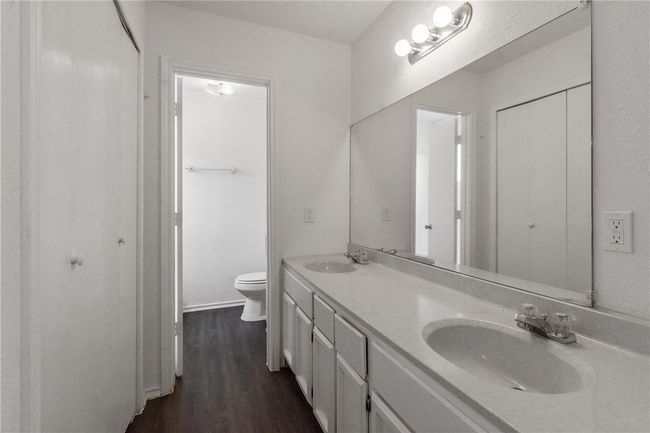 Primary bathroom with dual vanity. Cabinets painted in February 2022. | Image 12
