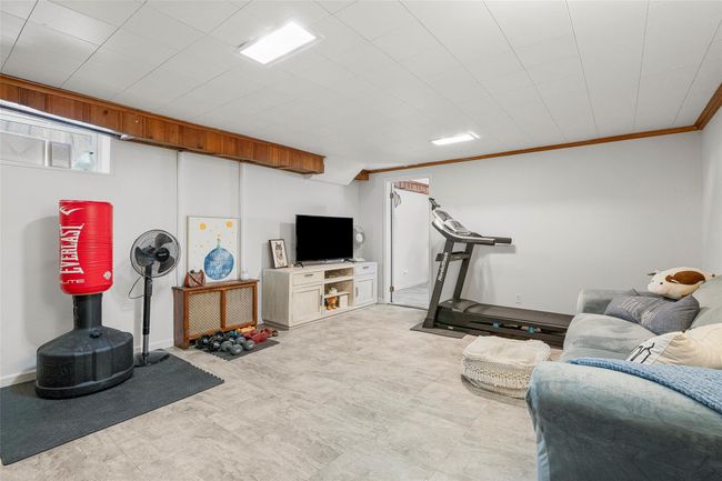 Basement exercise area with crown molding and baseboards | Image 17