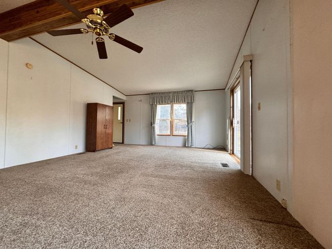 Open layout living room to the kitchen. Living room also has a patio door to the deck | Image 7