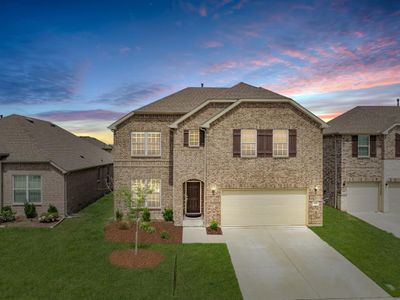 View of front facade featuring a garage and a lawn | Image 1