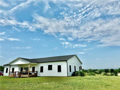 View of front of house featuring a front lawn and a wooden deck | Image 3