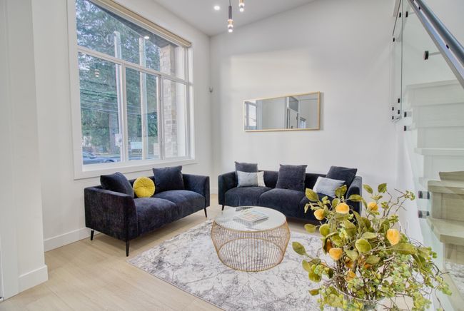 Living area with wood finished floors, stairs, and baseboards | Image 4