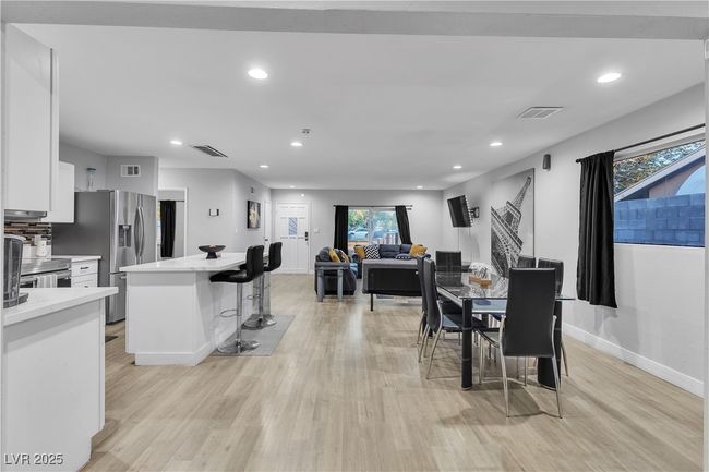 Dining area with baseboards, visible vents, light wood-type flooring, and recessed lighting | Image 4