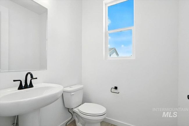 Bathroom featuring a sink and baseboards | Image 23
