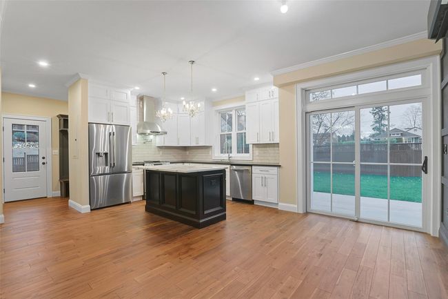 Sliding doors to back yard bathes the space in natural light. | Image 17