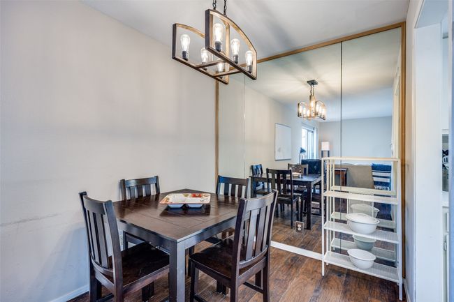 Dining room with a chandelier and wood finished floors | Image 6