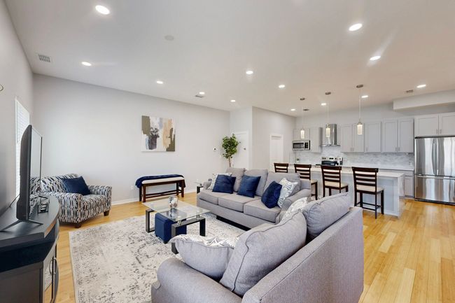 Living room featuring light wood-style flooring, recessed lighting, and baseboards | Image 19