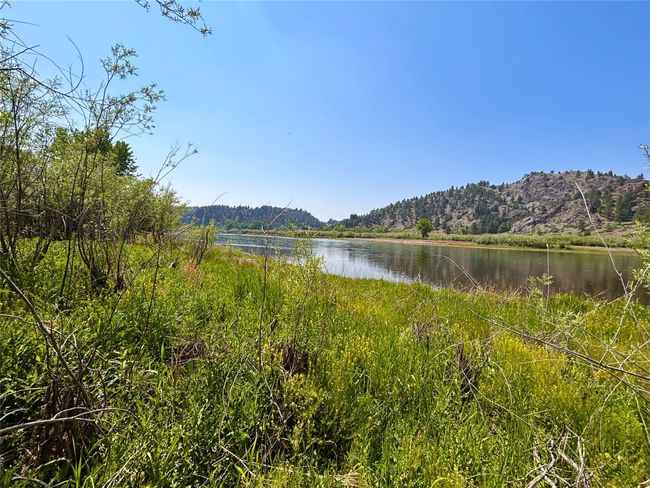 Water view with a mountain backdrop and a forest | Image 33