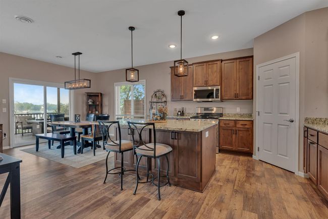 Custom, soft close knotty elder cabinetry throughout the entire home. Great flow from room to room | Image 7