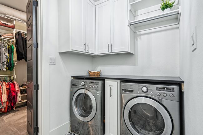 Washroom with washer and clothes dryer, cabinet space, and carpet flooring | Image 22