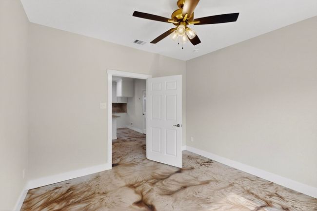 Empty room featuring a ceiling fan and baseboards | Image 34