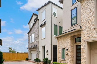 This home offers a two-car garage and a private front entrance, complete with a spacious covered patio. | Image 3