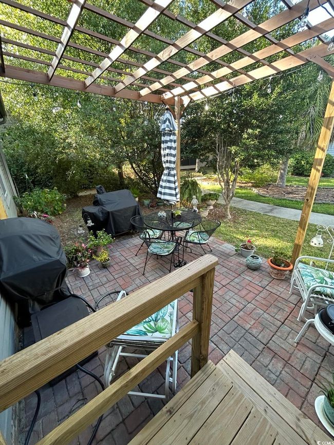 View of patio / terrace with area for grilling, outdoor dining area, and a pergola | Image 30