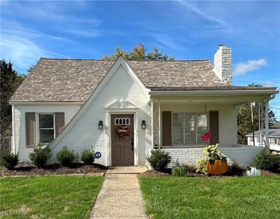 Bungalow-style house featuring a front yard and a porch | Image 1