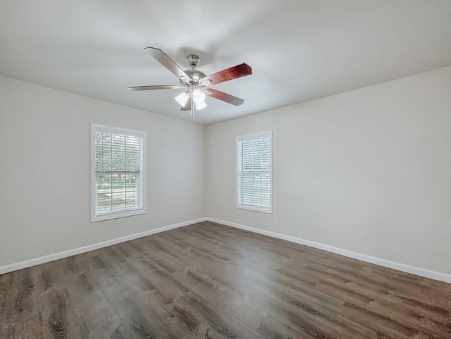 Unfurnished room with wood finished floors and ceiling fan | Image 24