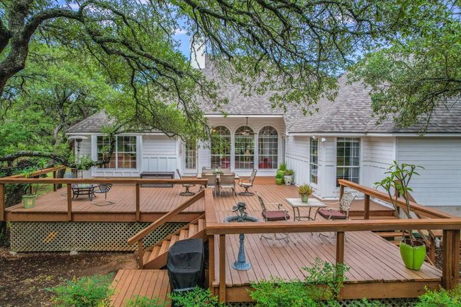 Mature trees dot the landscape, creating natural beauty and shade throughout the yard. | Image 29