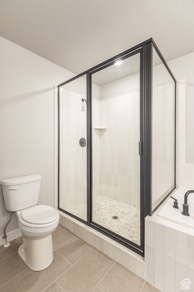 Bathroom with a garden tub, a shower stall, and tile patterned floors | Image 19