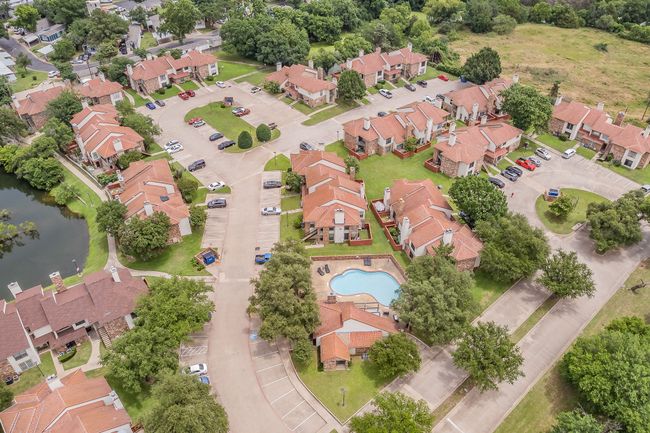 Aerial view of residential area featuring a large body of water and a pool area | Image 31