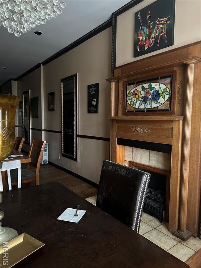 Dining area with ornamental molding, wood finished floors, and baseboards | Image 14