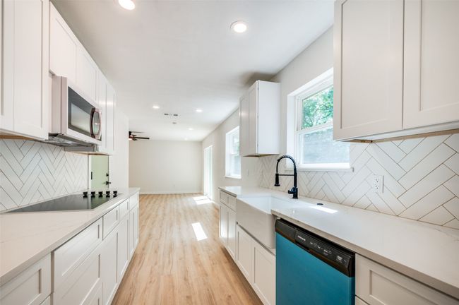 Single story home with driveway, an attached garage, and brick siding | Image 18